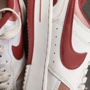 Gently used Nike White with accents in salmon and red